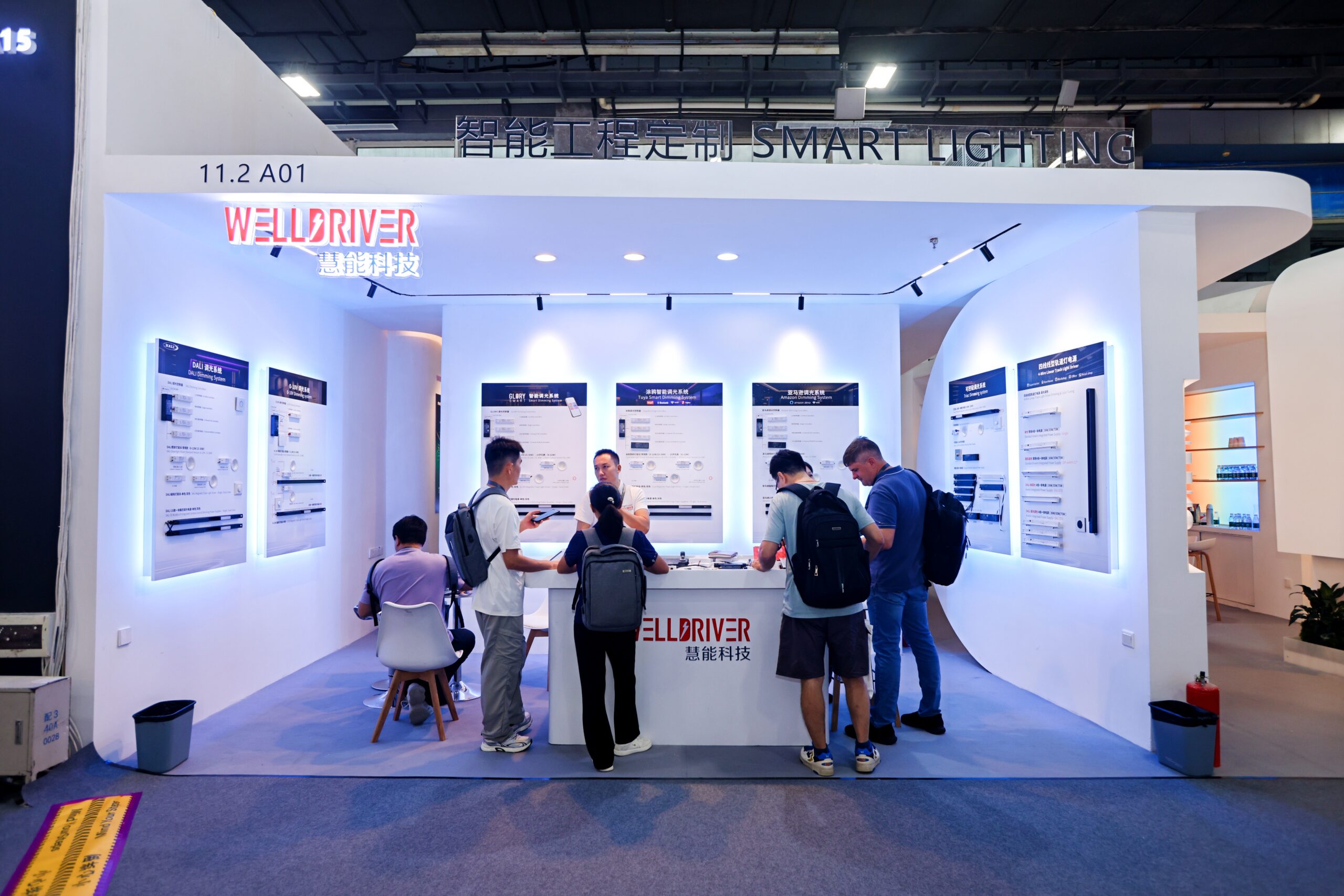 International visitors engage with WELLDRIVER representatives discussing LED driver and controller products at the 2026 Guangzhou International Lighting Exhibition.